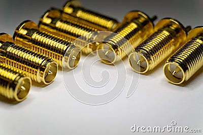 Close-up of symmetric aligned gold plated SMA male connectors electronics components in partial focus white background Stock Photo