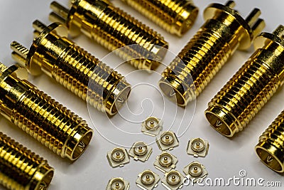 Close-up of symmetric aligned gold plated uFL micro precision radio connector in partial focus white and SMA background Stock Photo