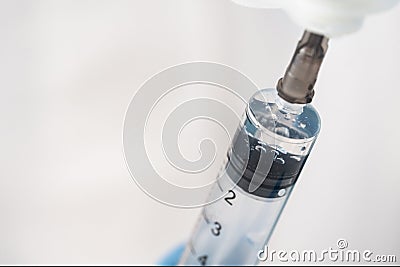 Close-up of a syringe with a dose of medicine for viruses and infections. Stock Photo