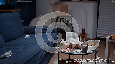 Close up of table with leftover on it in empty unorganized messy living room Stock Photo