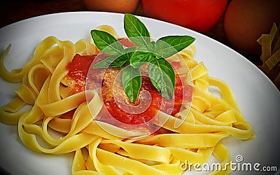 Tagliatelle, tomato and basil plate Stock Photo