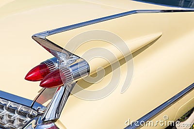 Close-up of tail light and rear part of retro car. Detail of vintage classic vehicle. Wing fender with chrome bumper and red brake Stock Photo