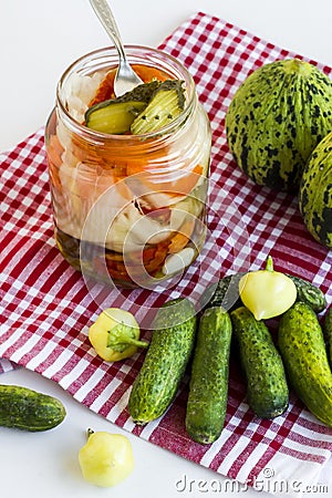 Mixed pickle jar with unripe,pickled vegetables on white background Stock Photo
