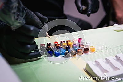 Close-up of tattoo artist work place parts and paint, machines and other equipment. Professional tattooist working Stock Photo