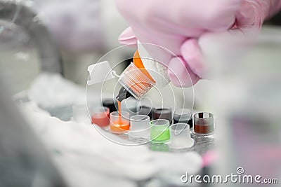 Close-up of a tattoo master pours various ink into special containers before applying a tattoo. Preparation of tools and Stock Photo
