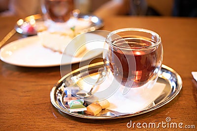 Close up tea cup on table in cafe with blur light bokeh Stock Photo