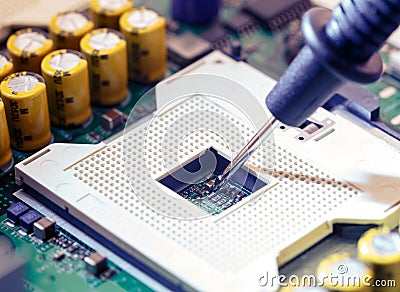 Close Up - Technician engineer measuring multimeter CPU socket computer motherboard Stock Photo