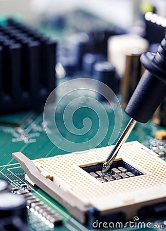Close Up - Technician engineer measuring multimeter CPU socket computer motherboard Stock Photo
