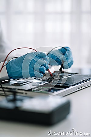 Close up of Technician measuring voltage electronic circuit board, Service after sale fix electric equipment Stock Photo