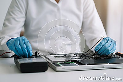 Close up of Technician measuring voltage electronic circuit board, Service after sale fix electric equipment Stock Photo