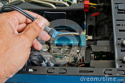 Close up of a technician's hands wiring computer parts Stock Photo