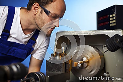 Close-up of technician working on lathe machine Stock Photo