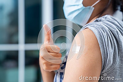 Close up of teens girls and wear a mask in the shoulder with plaster on arm after vaccination in hospital Stock Photo