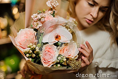 Close-up of tender pink bouquet of orchids and roses in woman`s hands Stock Photo