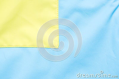 Close-up of textured fabric cloth textile background, Yellow and blue part of jacket Stock Photo