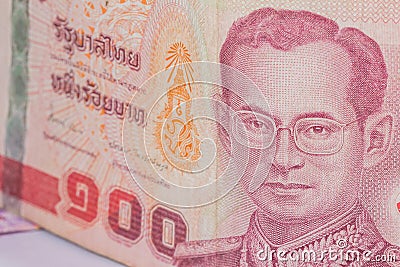 Close up of thailand currency, thai baht with the images of Thailand King. Denomination of 100 bahts Stock Photo