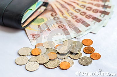 Close up of Thailand money bath with black wallet on white backg Stock Photo