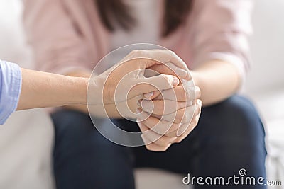 Close up of therapist touching woman patient hands Stock Photo