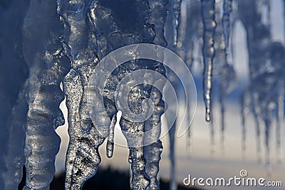 close up of thick blue ice and many icicles Stock Photo