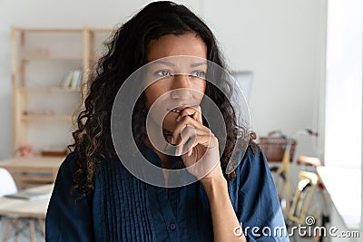 Pensive biracial female employee look in distance Stock Photo