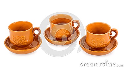 Three clay teacups with saucers Stock Photo