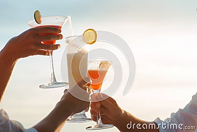 Close up of three friends clinking with glasses cocktail Stock Photo