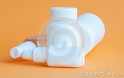 Close-up of three portable plastic bottles with tablets and vitamins and one transparent plastic bottle with a disinfectant Stock Photo