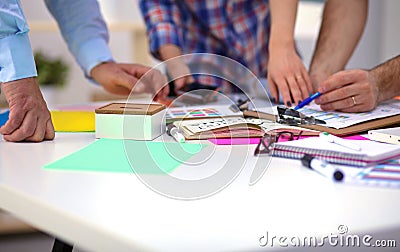 Close-up of three young creative designers working on project together. Team work Stock Photo