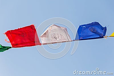 Tibetian prayer flags waved against blue sky Stock Photo