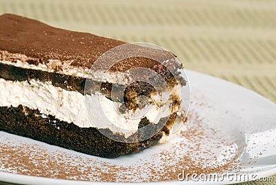 Close up tiramisu with cocoa powder on green table Stock Photo