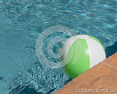Top view close-up beach ball near swimming pool coping Stock Photo