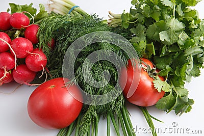 Close up top view shot of a vegetable composition consisting of a bunch of radish, dill, parsley, green onions and ripe red Stock Photo