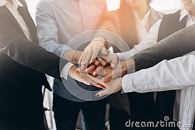 Close up top view of young business people putting their hands together. Stack of hands. Unity and teamwork concept Stock Photo