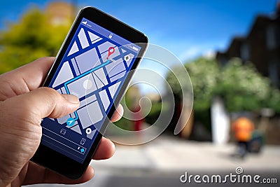 Close up of Tourist using GPS map navigation on smartphone application screen for direction to destination Stock Photo