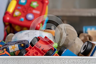 Close up of toys, with many different objects including soft toys, play cars and toddler toys Stock Photo