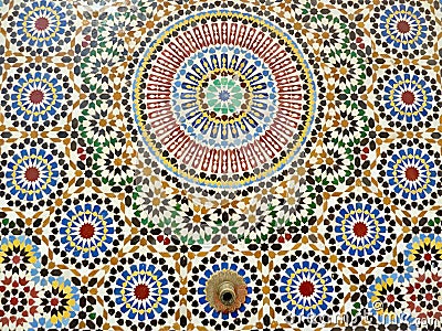 Close up traditional fountain, colorful glazes ceramic wall tiles in Islamic design. Rabat, Morocco. Stock Photo