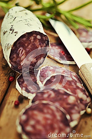 Traditional sliced meat sausage salami on wooden board Stock Photo