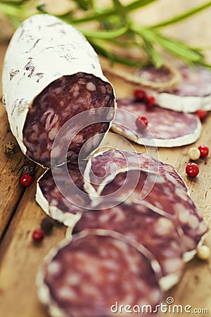 Traditional sliced meat sausage salami on wooden board Stock Photo