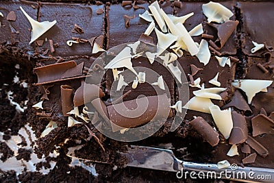 A close up of a tray bake chocolate cake with a few slices removed. Stock Photo