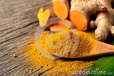Close-up Turmeric curcumin powder in wooden spoon Stock Photo
