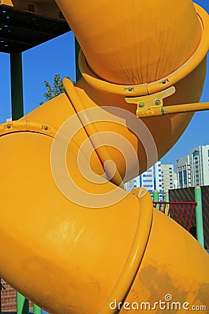 Close up of a twisted yellow tube slide Stock Photo