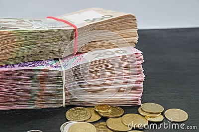 Close-up of two bundles of hryvnia and coins. Financial concept. Ukrainian banknotes of 500 and 200 hryvnia. Lots of banknotes. Mo Stock Photo