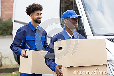 Two Men Holding The Cardboard Boxes Stock Photo