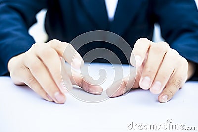 Close up of two hands of a business man wearing blue suit isolated on white trying to save something imagery. Stock Photo