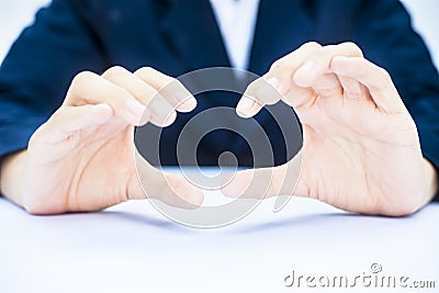 Close up of two hands of a business man wearing blue suit on white trying to save something imagery. Stock Photo