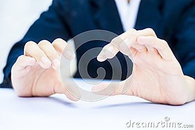 Close up of two hands of a business man wearing blue suit on white trying to save something imagery. Stock Photo