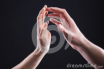A close-up of two hands male and female gently touch each other. The concept of tremulous rejection between the sexes Stock Photo