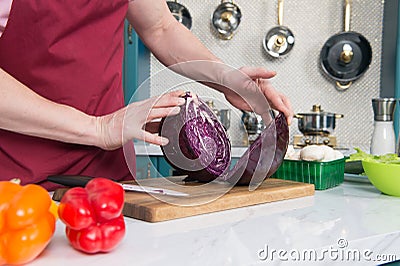 Close up of two part of red cabbage on table. Cook hold of two parts of red cabbage. Closeup of two parts of cabbage Stock Photo