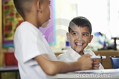 Close up of two primary school boys interacting in class Stock Photo