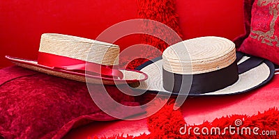 Close Up of Two Straw Hats on Red Gondola Seats In Venice Stock Photo